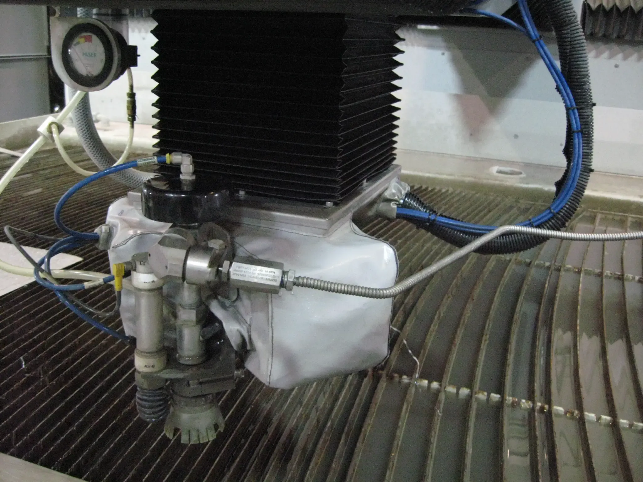 Abrasive waterjet cutting head in operation